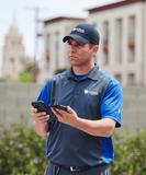 Installer scanning for signals using a signal meter.